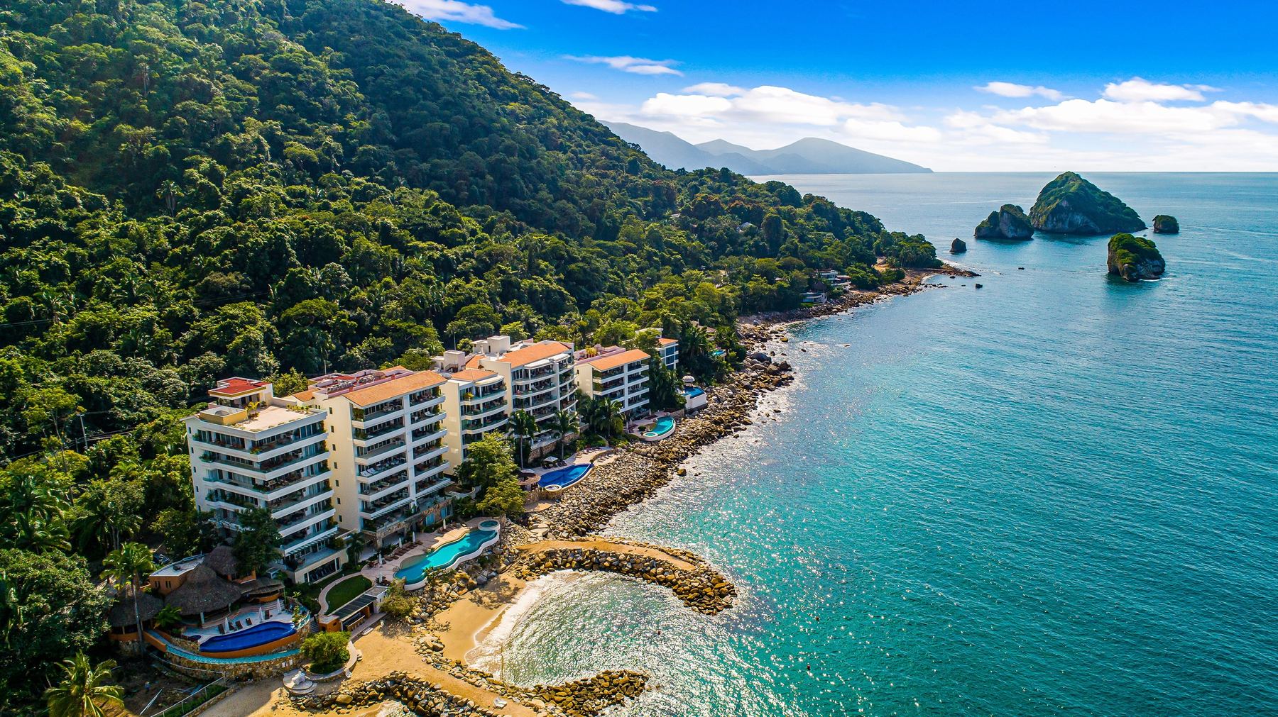 Aerial view of the Puerto Vallarta cove: turquoise water framed by forested mountains