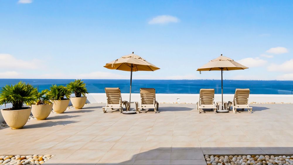 Sun deck with umbrellas and loungers over the ocean