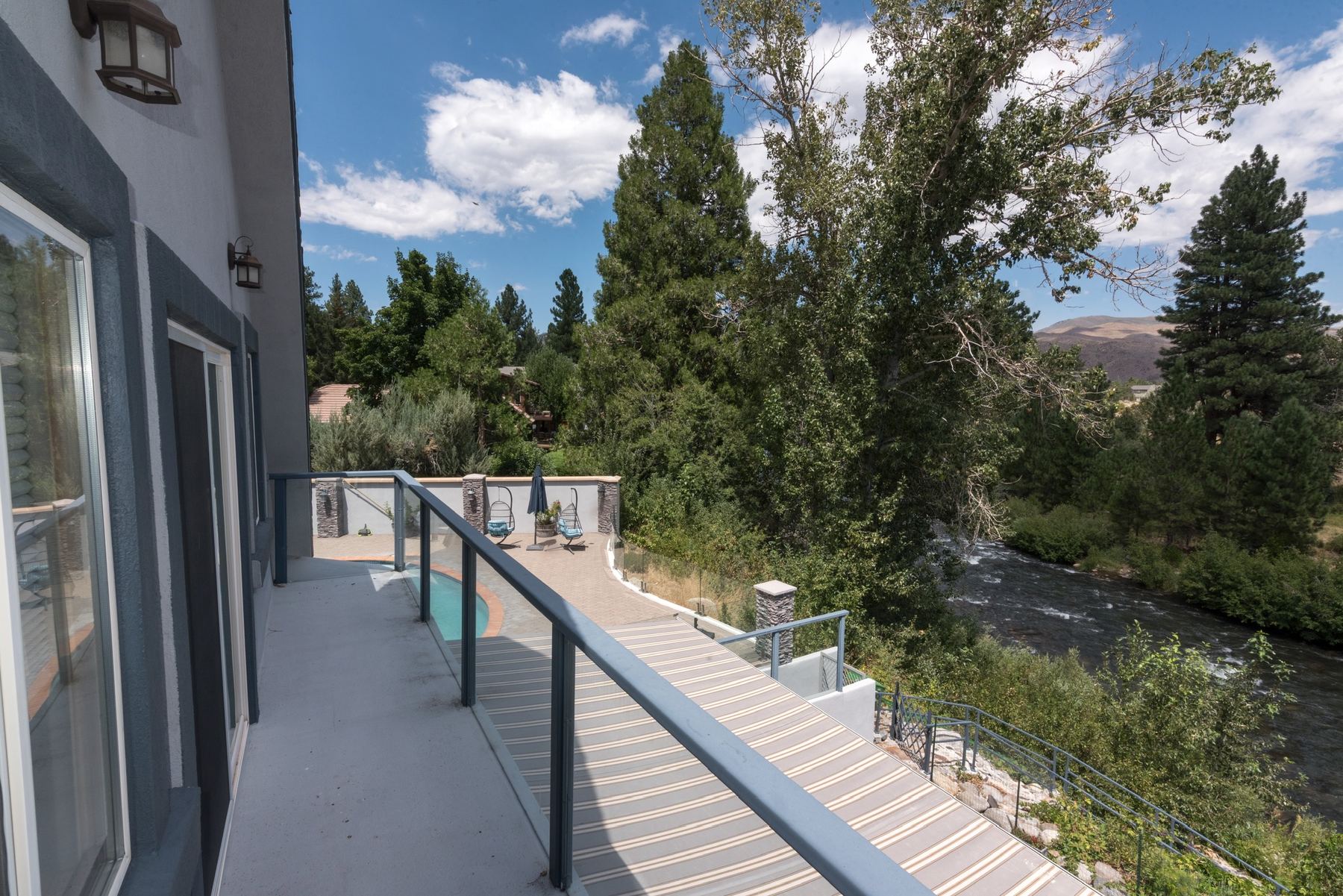 Upper deck at Bonnie's Nest Too overlooking the pool, the Truckee River and the mountains